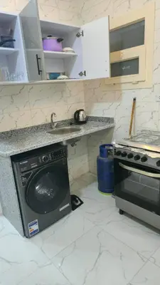 a kitchen with a dishwasher and a sink and a stove at البحر الاحمر الغردقه in Hurghada