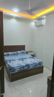 a bedroom with a bed in a white room at البحر الاحمر الغردقه in Hurghada