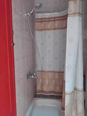 a bath tub with a shower head in a bathroom at Ramsess Hotel in Luxor