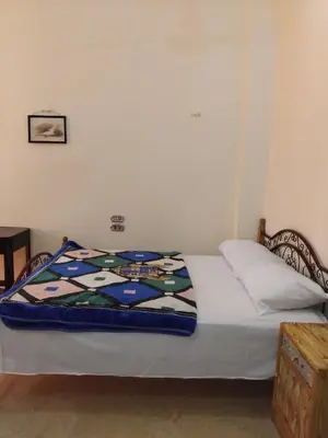 a bed with a quilt on it in a bedroom at Ramsess Hotel in Luxor