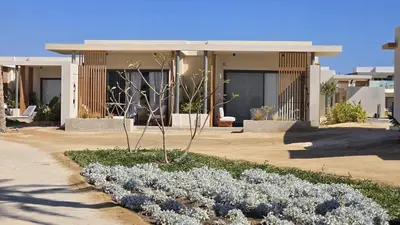 a house with a bunch of flowers in front of it at Modern Minimalist Beach & Pool Side Somabay Cabana in Hurghada