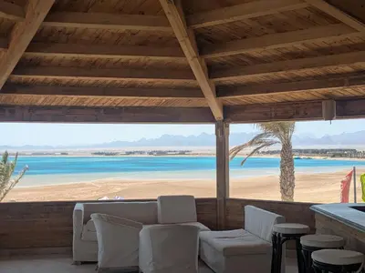 a porch with chairs and a view of the beach at Modern Minimalist Beach & Pool Side Somabay Cabana in Hurghada