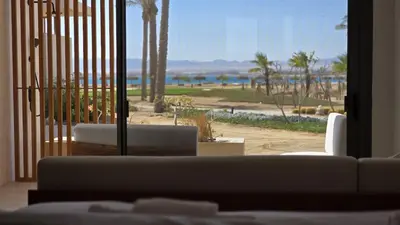 a living room with a couch and a view of the beach at Modern Minimalist Beach & Pool Side Somabay Cabana in Hurghada