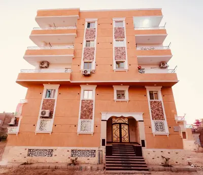 a building in the middle of a city at signature house Luxor in Luxor