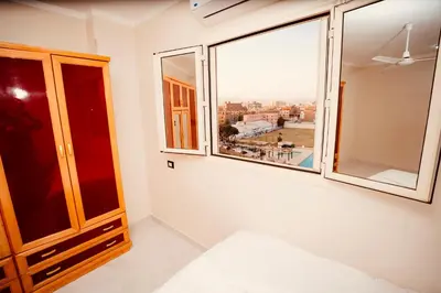 a room with windows with a view of the city at signature house Luxor in Luxor