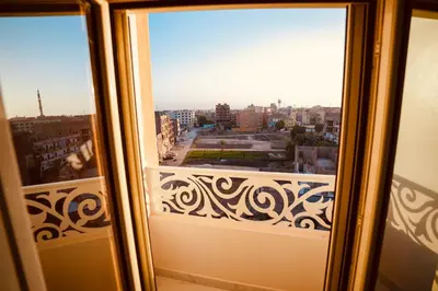 a window with a view of a city at signature house Luxor in Luxor