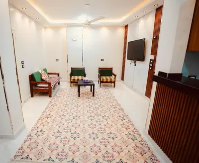 a living room with couches and a flat screen tv at signature house Luxor in Luxor