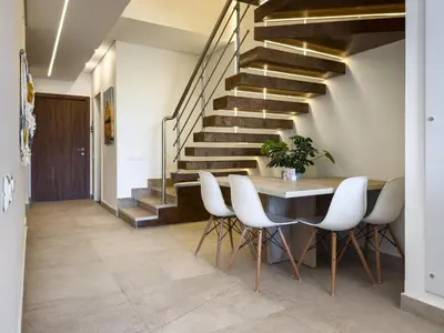 a dining room with a table and chairs and stairs at Poolside Townhome with 2 Masters, a Huge Terrace in El Gouna in Hurghada