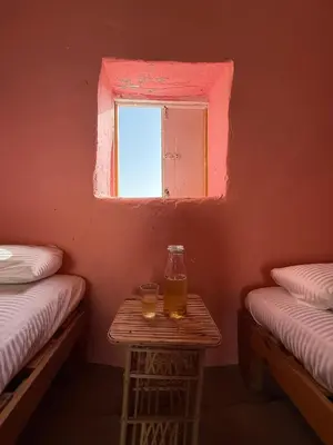 a room with two beds and a table with two glasses on it at Per Ankh - Heissa island - Aswan in Aswan