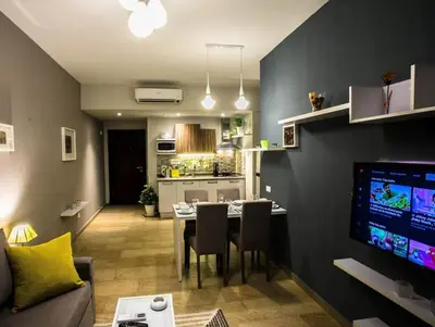 a living room with a dining table and a kitchen at Kite Lodging in Hurghada