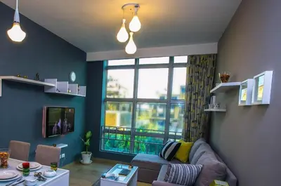 a living room with a couch and a large window at Kite Lodging in Hurghada