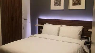 a bedroom with a large bed with white sheets and pillows at Kite Lodging in Hurghada