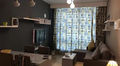 a living room with a couch and a large window at Kite Lodging in Hurghada