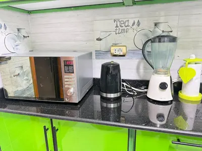 a kitchen counter with a microwave and a blender at King tut 7 in Aswān