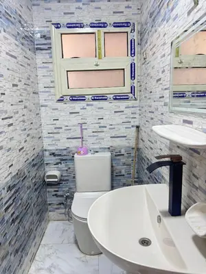 a bathroom with a white toilet and a sink at King tut 7 in Aswān