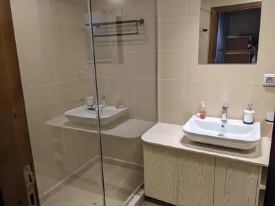 a bathroom with a sink and a glass shower at 2BR Pool Front Soma bay Villa Near Mesca Beach in Hurghada
