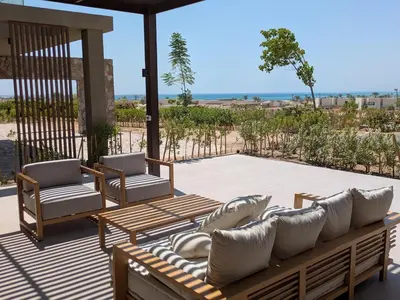 a patio with two chairs and a couch on a patio at Spacious 3BR Apartment Glorious Panoramic Seaviews in Hurghada