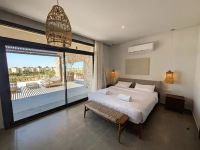 a bedroom with a large bed and a large window at Spacious 3BR Apartment Glorious Panoramic Seaviews in Hurghada