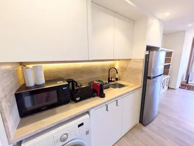 a kitchen with a microwave and a refrigerator at Beachy Pool side Mesca Cabana Somabay Steps to Sea in Hurghada