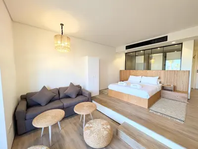 a living room with a couch and a bed at Beachy Pool side Mesca Cabana Somabay Steps to Sea in Hurghada