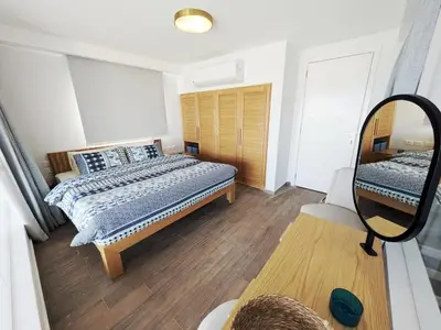 a bedroom with a bed and a mirror at Beautiful 2BR Mesca Beach Front Loft in Soma bay in Hurghada
