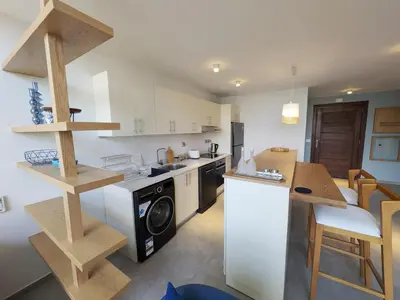 a kitchen with a washer and dryer in it at Beautiful 2BR Mesca Beach Front Loft in Soma bay in Hurghada