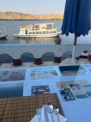 a table with a view of a boat on the water at Nubiana Boat