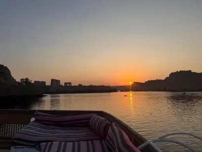 a boat on a river with the sun setting at Nubiana Boat