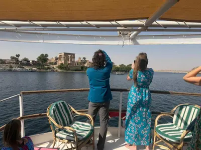 two women taking pictures on a boat on the water at Nubiana Boat