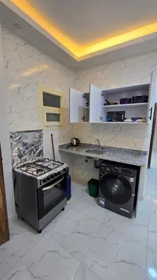 a kitchen with a stove and a stove top oven at عمارة الرومانى in Hurghada