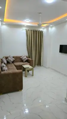 a living room with a couch and a table at عمارة الرومانى in Hurghada