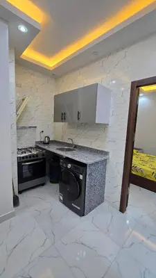 a kitchen with a stove and a dishwasher at عمارة الرومانى in Hurghada