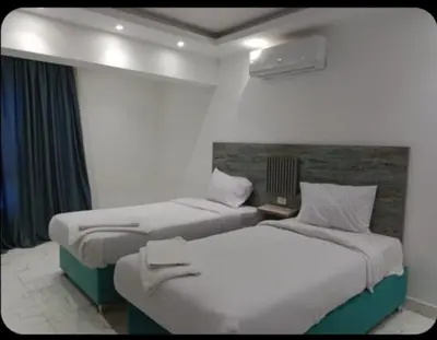 two beds in a hotel room with at الغردقه قريه فنادير باى in Hurghada