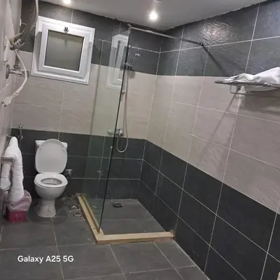 a bathroom with a shower and a toilet at الغردقه قريه فنادير باى in Hurghada
