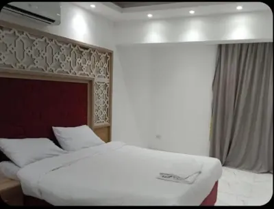 a bedroom with a large white bed and a window at الغردقه قريه فنادير باى in Hurghada