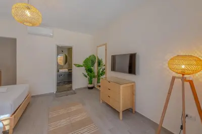 a room with a bed and a tv on a wall at Dreamy Studio in Bali Compound, El Gouna in Hurghada