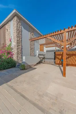 a house with a bench and a wooden pergola at Dreamy Studio in Bali Compound, El Gouna in Hurghada