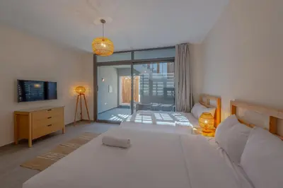 a bedroom with two beds and a couch and a television at Dreamy Studio in Bali Compound, El Gouna in Hurghada