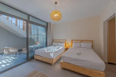 a bedroom with two beds and a balcony at Dreamy Studio in Bali Compound, El Gouna in Hurghada