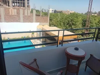 a balcony with a view of a swimming pool at Hamed's House Luxor in Luxor