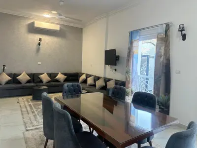 a conference room with a wooden table and chairs at Hamed's House Luxor in Luxor