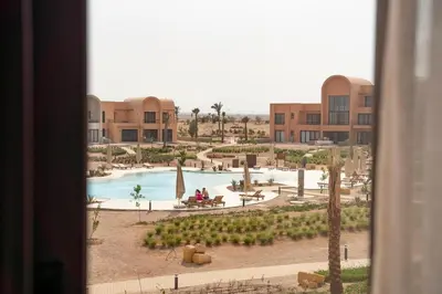 a view of a resort with a pool and buildings at Bright & Elegant 2BR Retreat - Kamaran El Gouna in Hurghada