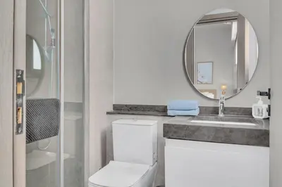 a bathroom with a toilet and a sink and a mirror at Bright & Elegant 2BR Retreat - Kamaran El Gouna in Hurghada