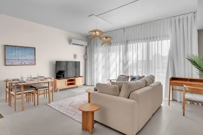 a living room with a couch and a table at Bright & Elegant 2BR Retreat - Kamaran El Gouna in Hurghada