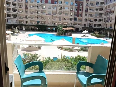 a view from the balcony of a hotel with chairs and a swimming pool at فلورانزا خمسين f012 in Hurghada