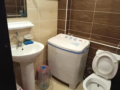 a small bathroom with a toilet and a sink at فلورانزا خمسين f012 in Hurghada