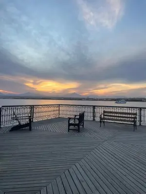 two benches sitting on a pier near the water at Tawaya Sahl Hasheesh 2 bedrooms in Hurghada