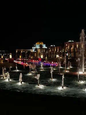 a fountain in front of a building at night at Tawaya Sahl Hasheesh 2 bedrooms in Hurghada