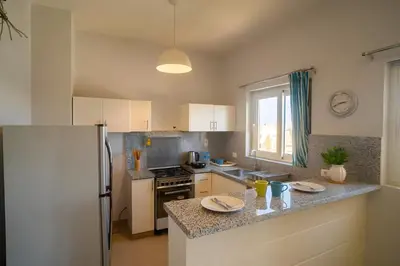 a kitchen with a refrigerator and a counter top at Stunning 4BD Apartment Lagoon View-Gouna in Hurghada