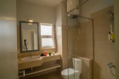 a bathroom with a sink and a toilet and a mirror at Stunning 4BD Apartment Lagoon View-Gouna in Hurghada